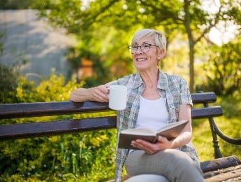 Senior Woman On Park Bench