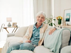 Seniors Woman On Couch Smiling