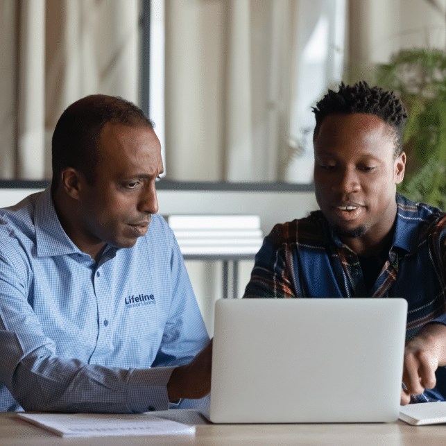 Two men at computer setting up new software